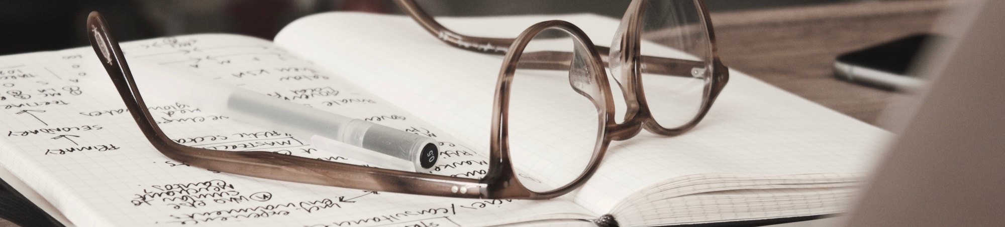 An image of glasses atop a notebook to suggest that gathering consumer perception could lead to actionable insights